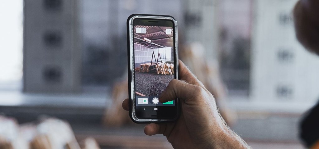 Construction worker using mobile data capture on jobsite.