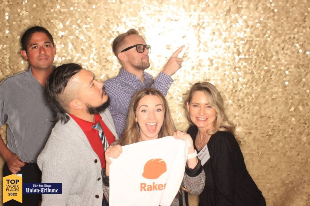 Raken employees posing with Raken towel.