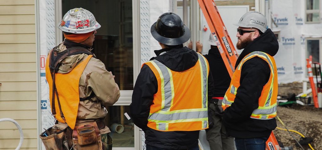 three construction workers on jobsite.