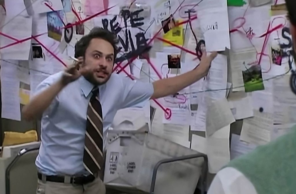distressed charlie kelly in front of cluttered paperwork.