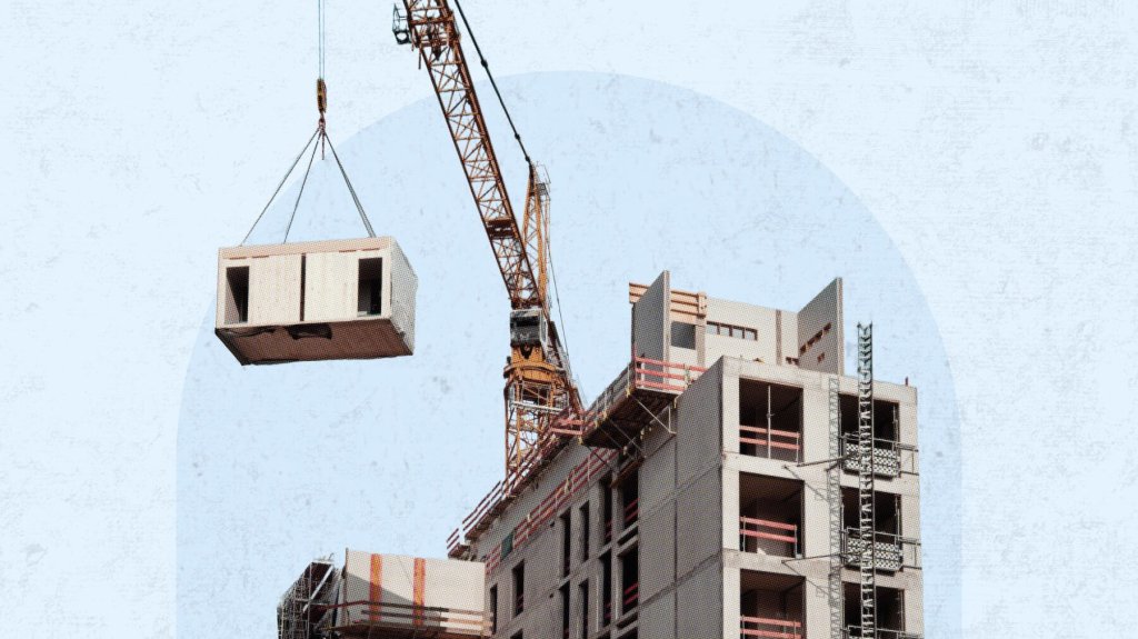 Crane lifting modular construction module on jobsite.