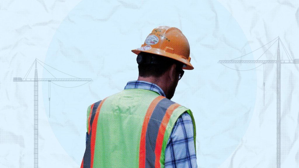construction worker in yellow vest turned away from camera.