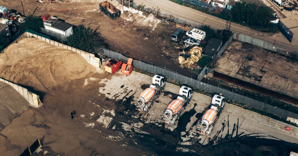 aerial shot of cement trucks on a jobsite.