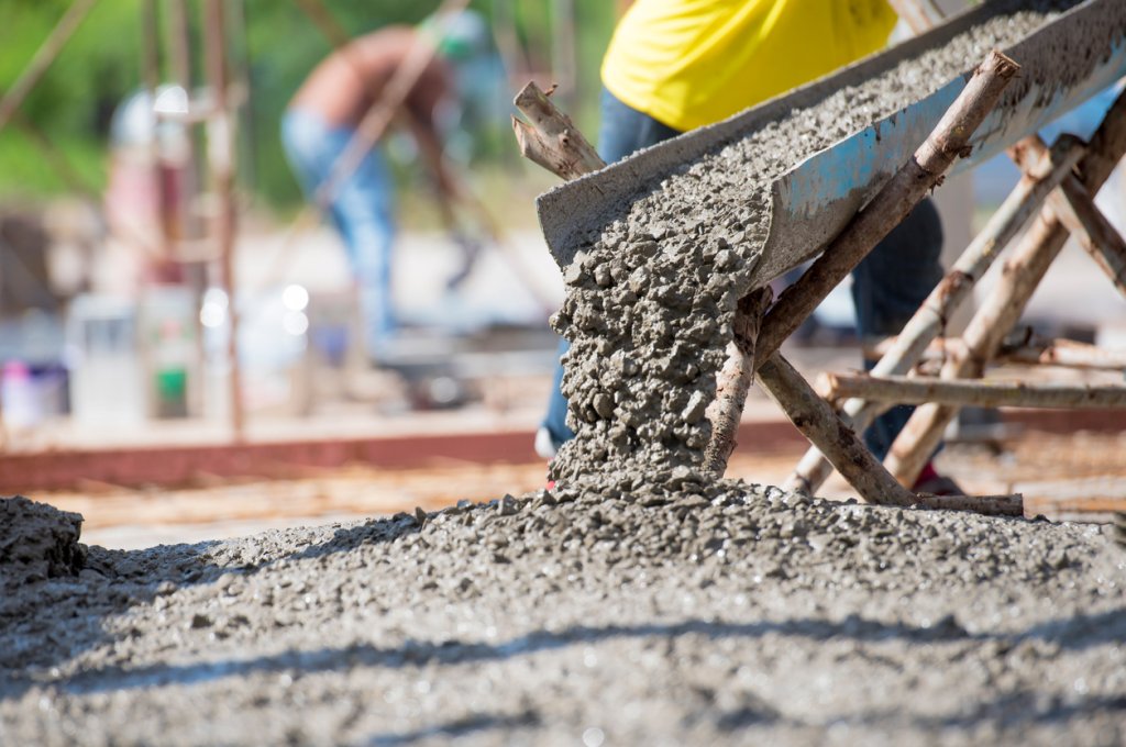 concrete being poured on construction site.
