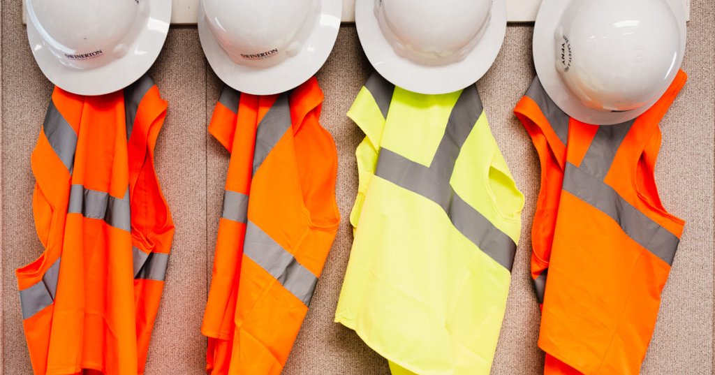 construction hard hats and safety vests.