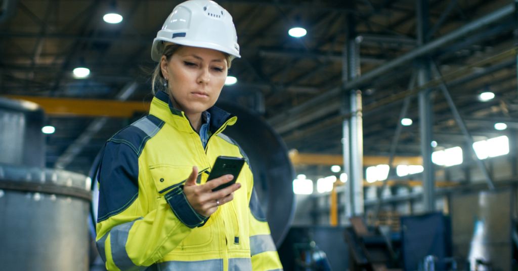 female construction worker using mobile phone.