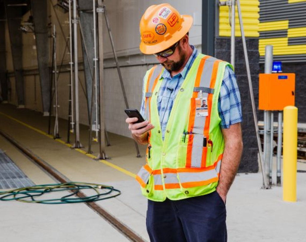 Contractor using mobile phone on jobsite.