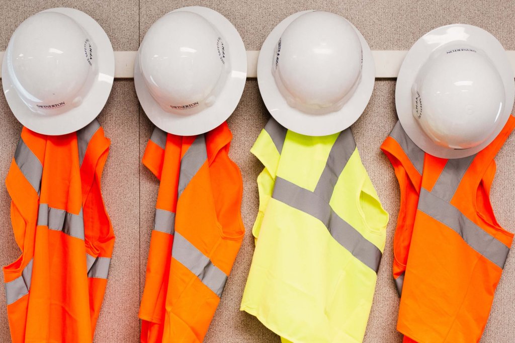 construction hard hats and safety vests.
