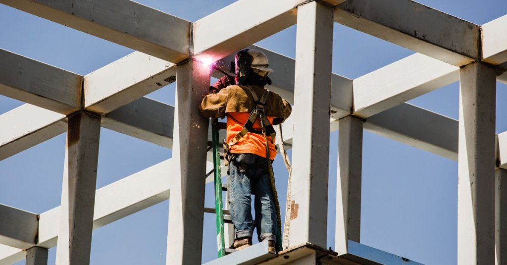 subcontractor welding on construction jobsite.
