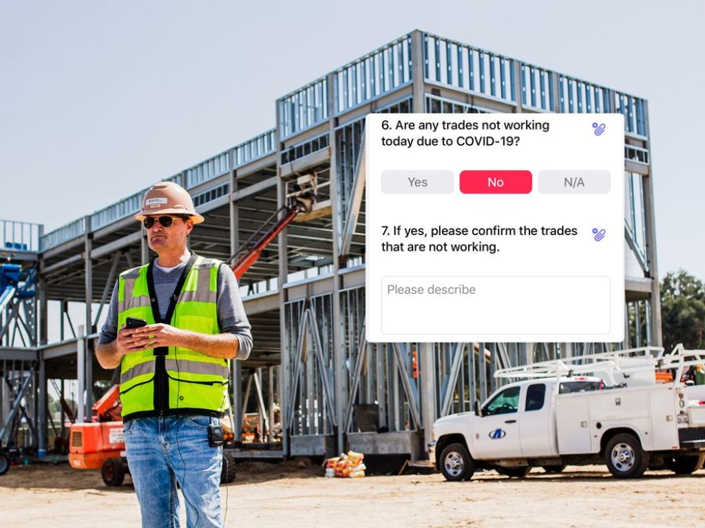 construction worker using checklist app on phone.