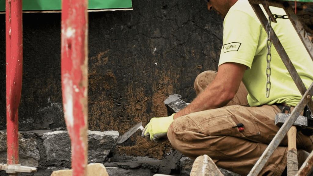 construction worker laying bricks.