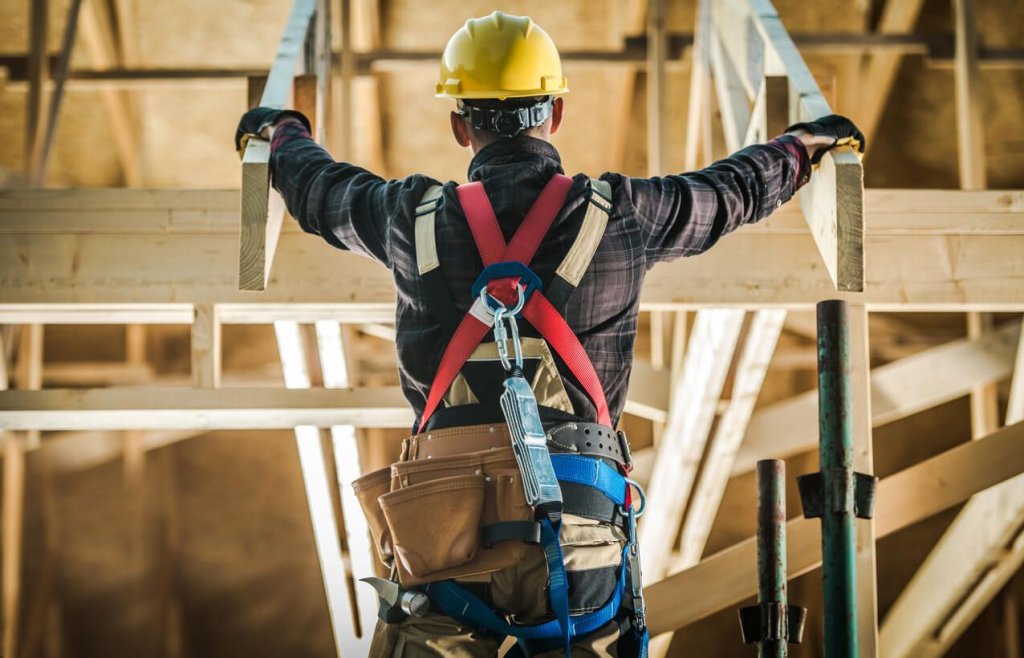 construction worker wearing safety harness.