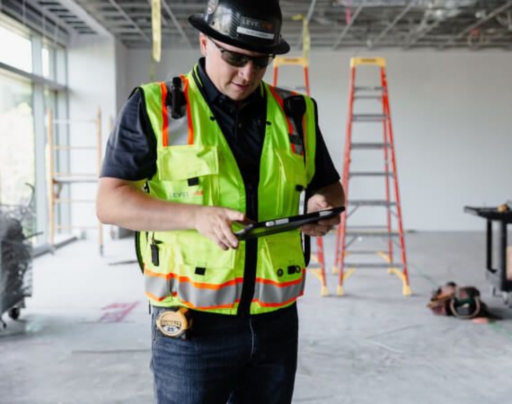 contractor using tablet on jobsite.