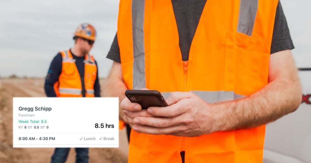 construction worker using digital time card app in field.